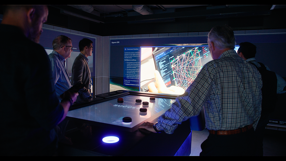 people-in-command-center-looking-at-datafeed